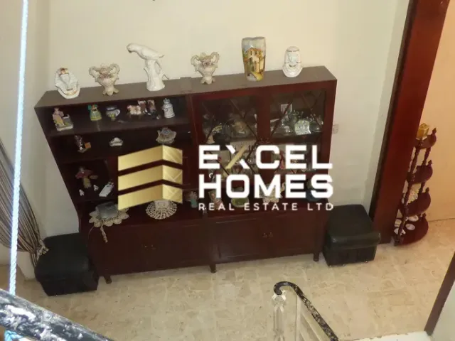 a room with a table with a large vase on it