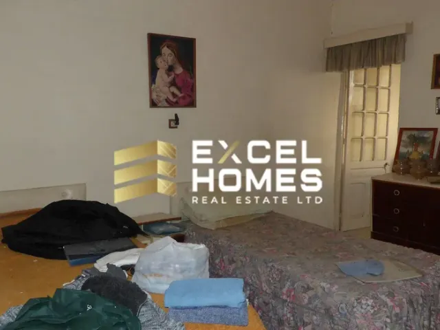 a bedroom with a bed, a dresser, and a lamp