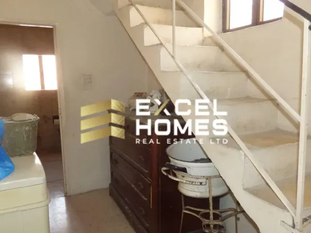 a bathroom with a toilet and a stairway