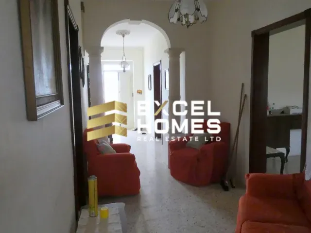 a living room with a couch, chair, and a table