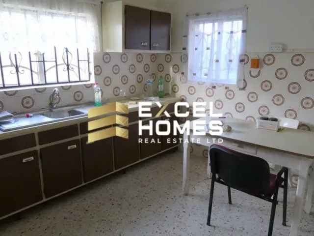 a kitchen with a sink, a stove, and a window