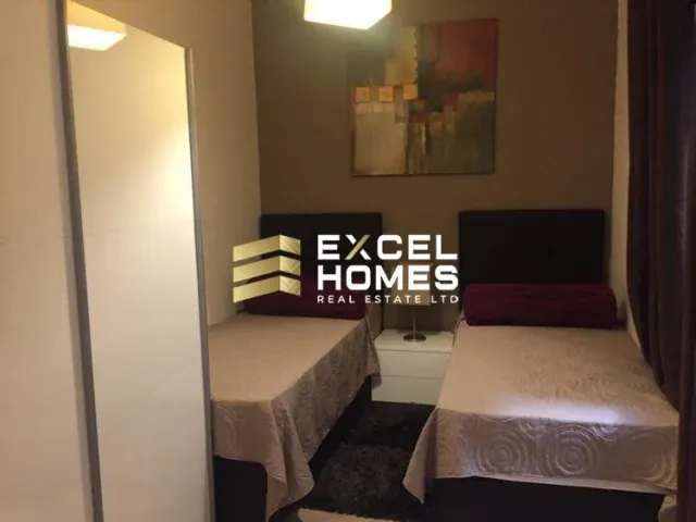 a hotel room with a bed and a television