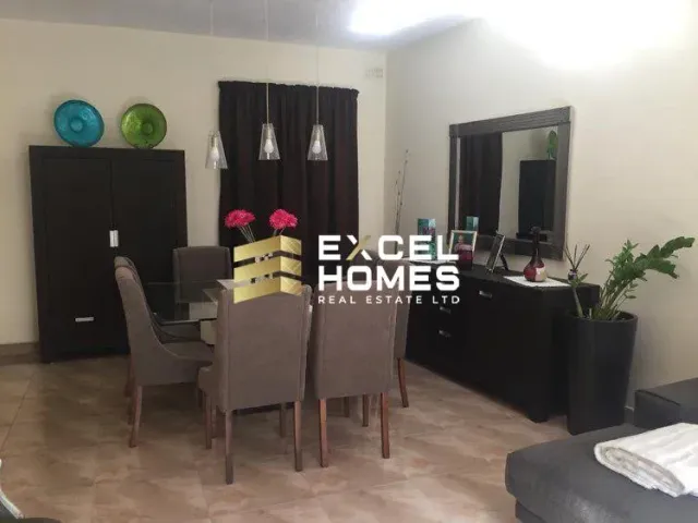 a living room with a table and chairs