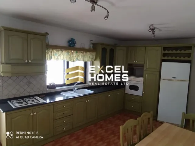 a kitchen with a stove, refrigerator, sink and a microwave