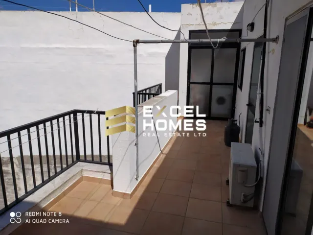 a white door leading to a building with a sign