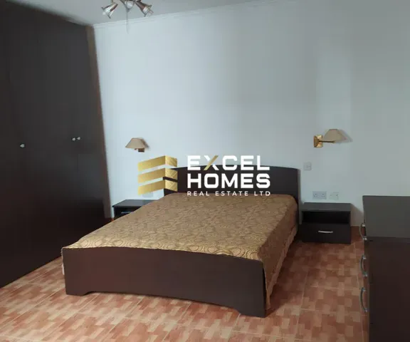 a bed with a white bedspread and a black and white bedspread