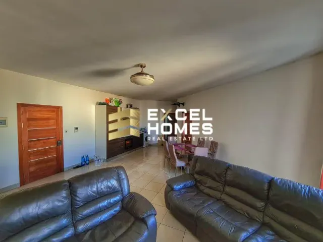 a living room with a couch, chair, and a television