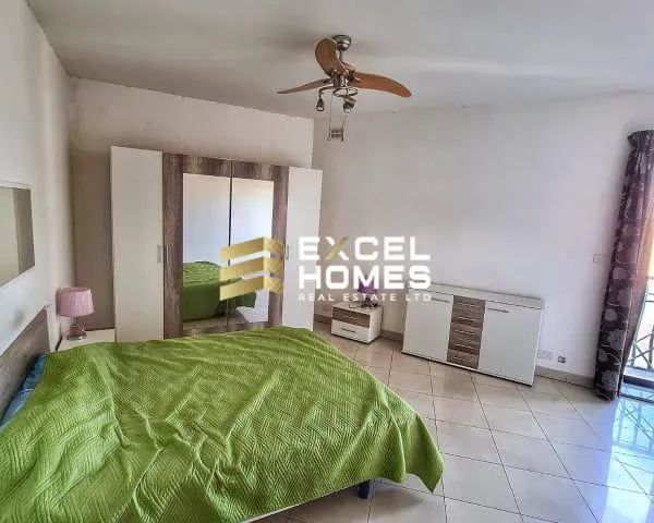 a bedroom with a bed and a chair