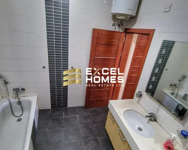 a bathroom with a bathtub, sink, mirror and a bath tub