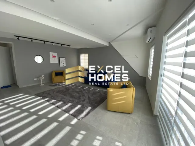 a room with a bed, chair, and a desk