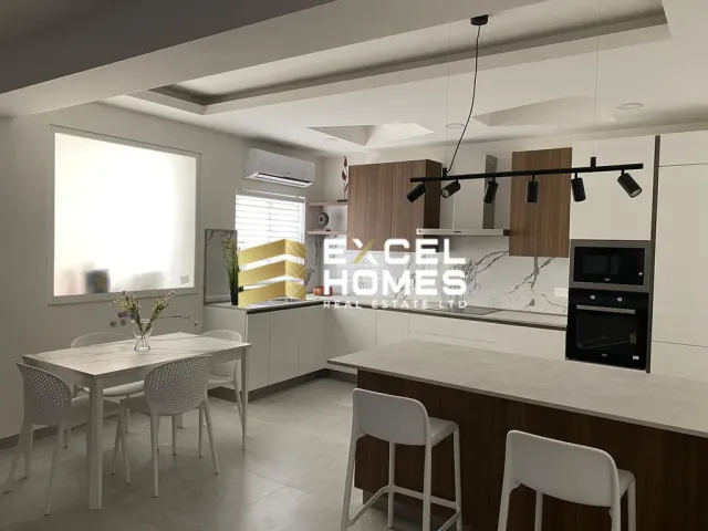 a kitchen with a white table and a white refrigerator