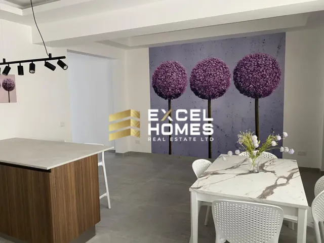 a room with a table and chairs with a picture of a cat on the wall