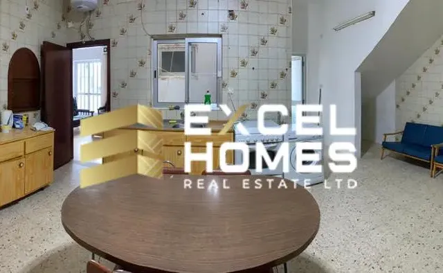 a kitchen with a table and a table cloth