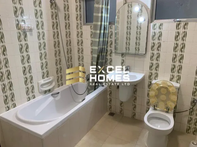 a bathroom with a toilet, sink, and bathtub