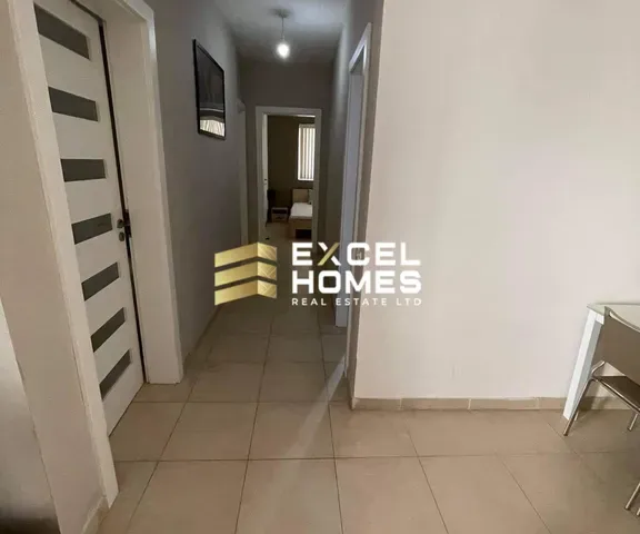 a hallway with a door and a toilet