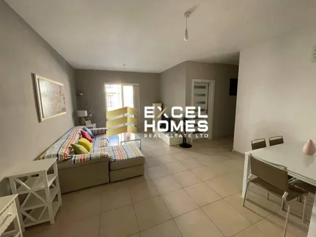 a room with a table, chairs, and a wall