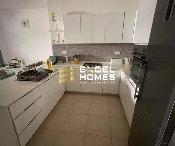 a kitchen with a stove, sink, and refrigerator