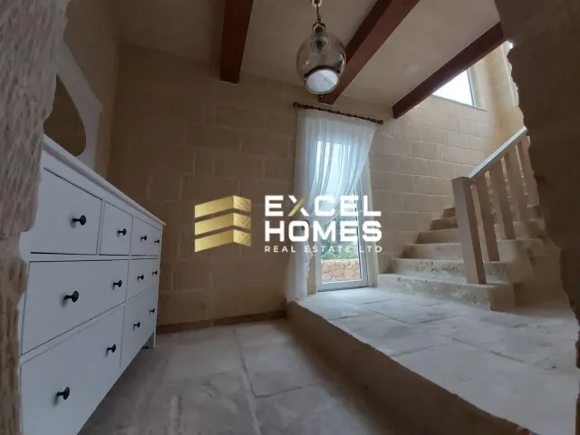 a room with a bed, a mirror and a window