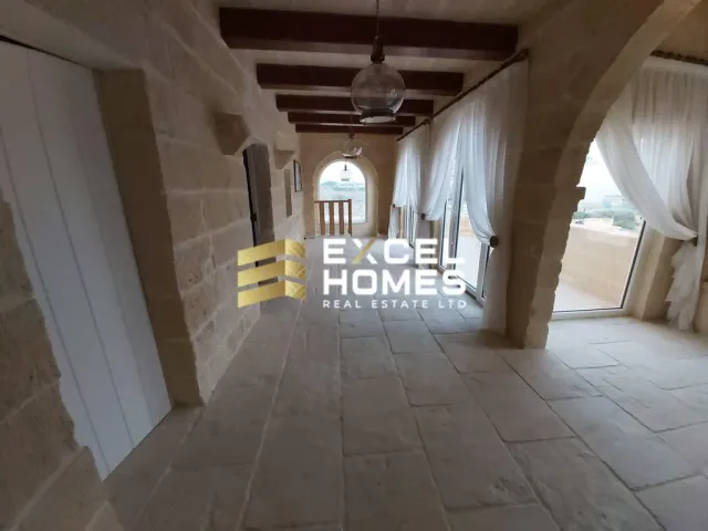 a room with a large window and a large wooden floor