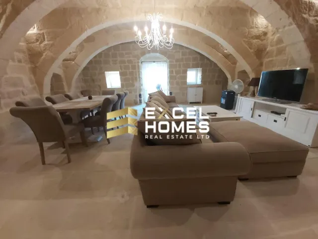 a living room with a large tv and a large couch