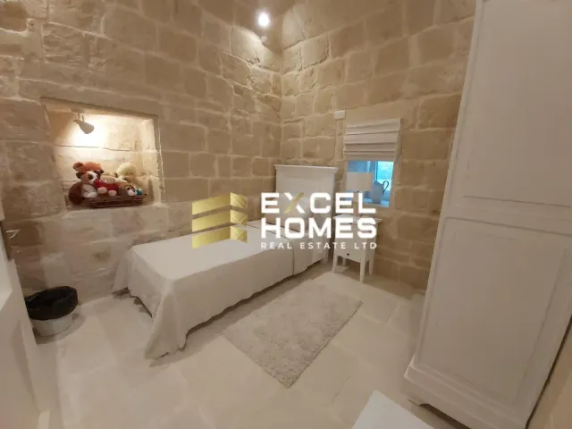 a bedroom with a bed and a wall