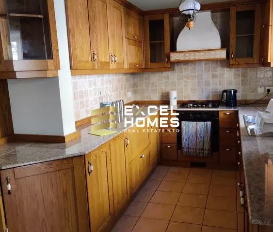 a kitchen with a stove, sink, and cabinets