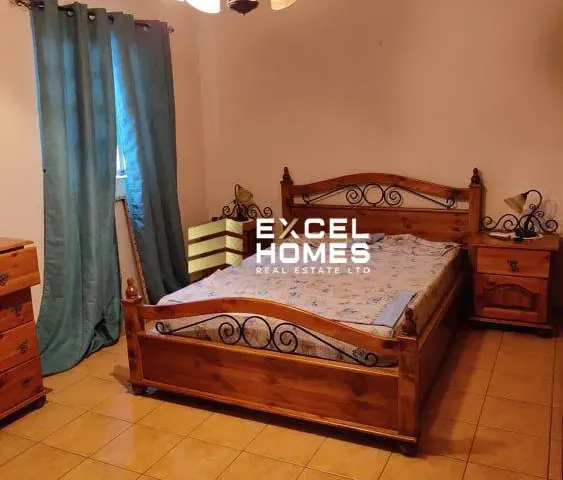 a bed with a wooden headboard and a bedspread