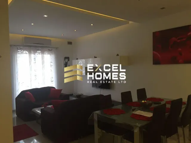 a living room with a couch, table, and chairs