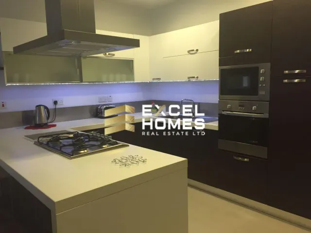 a kitchen with a microwave, sink, and refrigerator