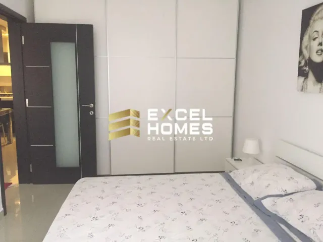 a bedroom with a bed, a mirror and a bed