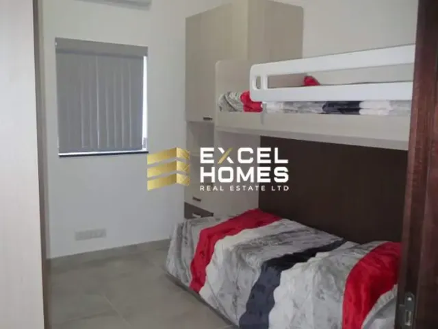 a bedroom with a bed, dresser, and a mirror