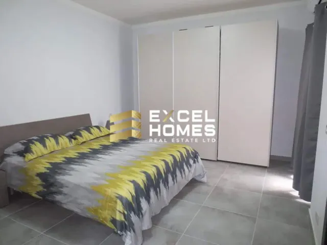 a bed with a white bedspread and a blue comforter