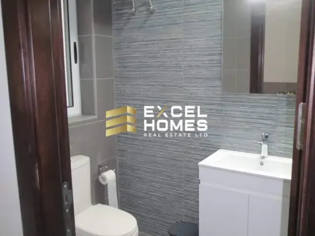 a bathroom with a toilet and a mirror