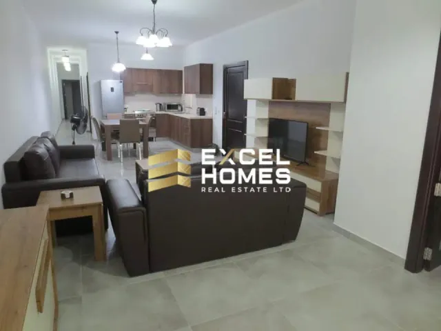 a living room with a couch, chairs, and a table