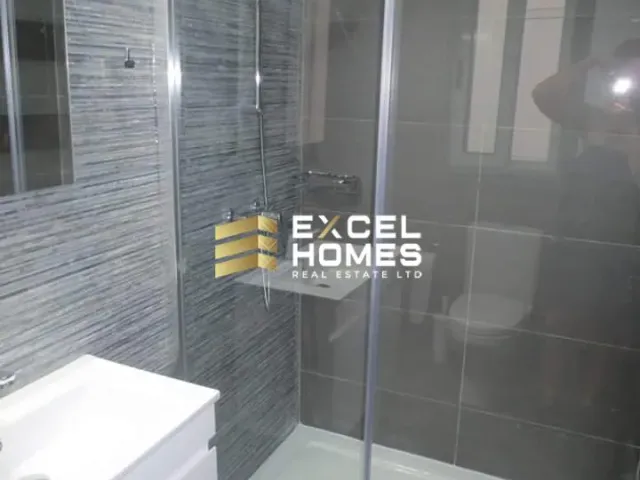 a bathroom with a shower stall and a toilet