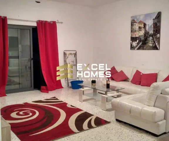 a living room with a couch, coffee table, and a rug