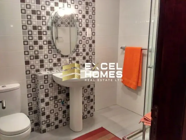 a bathroom with a toilet, sink, and shower