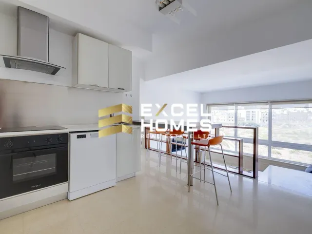 a kitchen with a stove, refrigerator, microwave and a table