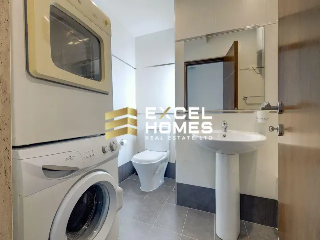 a bathroom with a sink, toilet and a microwave