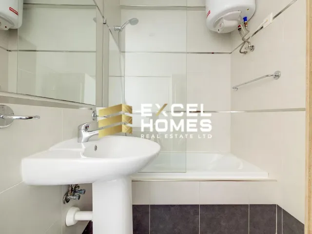 a bathroom sink with a mirror and a white towel