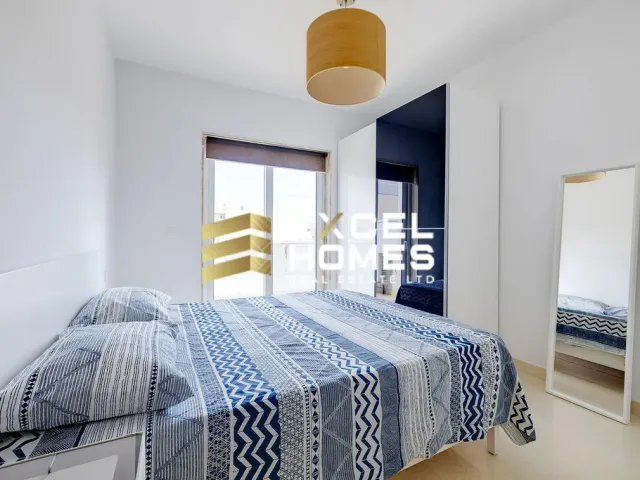 a bedroom with a bed, a dresser, and a window