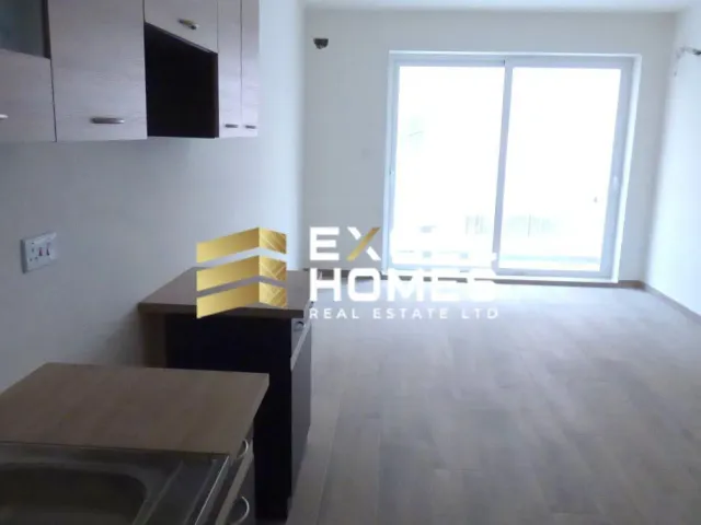 a kitchen with a sink, a toilet and a window 