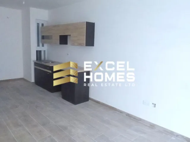 a kitchen with a white refrigerator and a black counter 