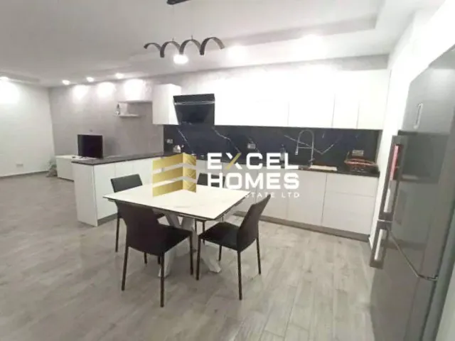 a kitchen with a table and chairs and a refrigerator