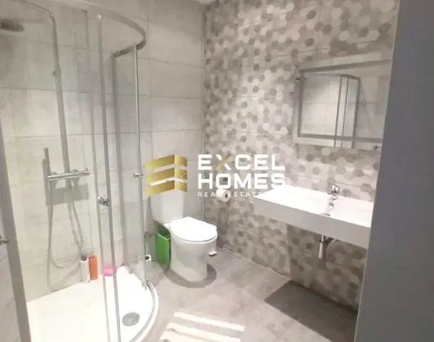 a bathroom with a toilet, sink, and shower