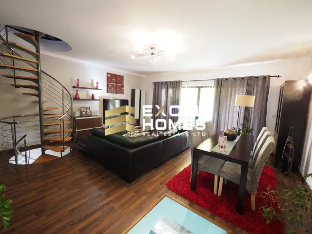 a living room with a couch, coffee table and a tv 