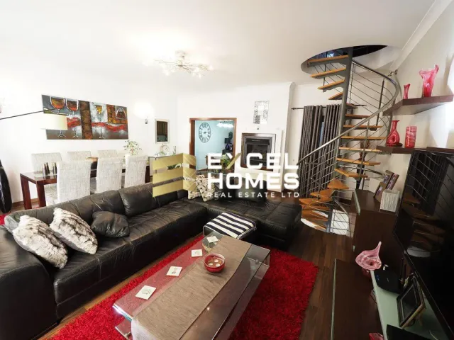 a living room with a couch, coffee table and a television 