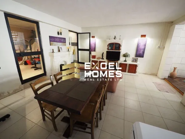 a kitchen with a table and chairs and a table cloth 