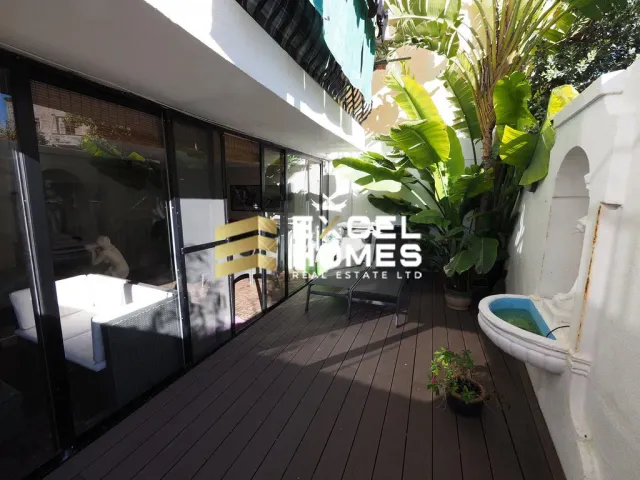a bathroom with a balcony and a walk in shower 