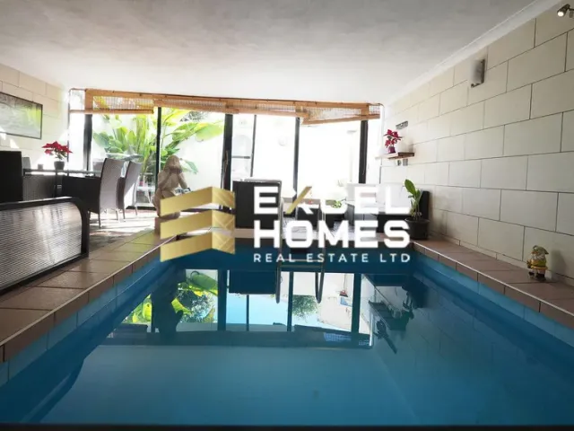 a swimming pool with a blue and white tub 